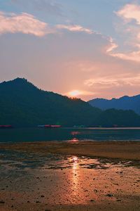 Scenic view of lake against sky during sunset