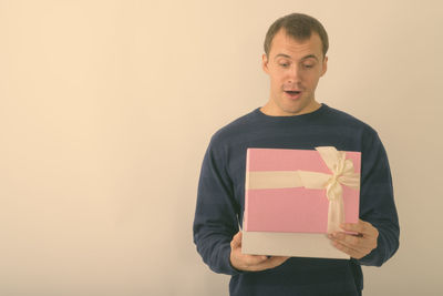 Portrait of smiling man standing against white background