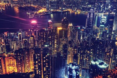 High angle view of illuminated modern buildings in city at night