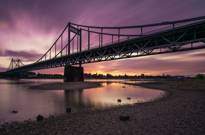 Bridge over river during sunset