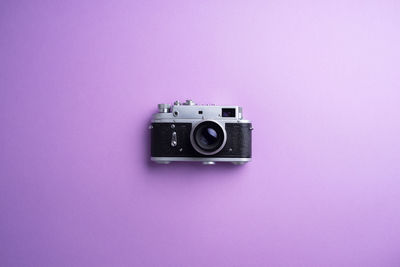 Close-up of camera on colored background