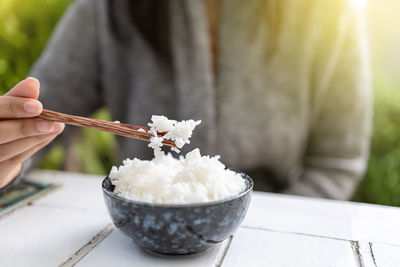 Person holding ice cream in bowl