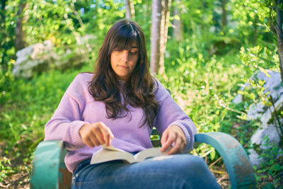 Young woman sitting outdoors