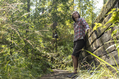 Full length of woman walking in forest