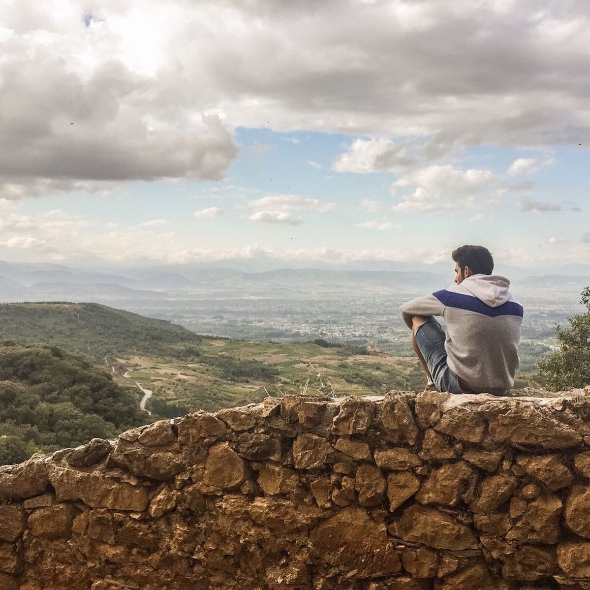 sky, cloud - sky, cloudy, rock - object, tranquil scene, scenics, tranquility, lifestyles, leisure activity, rear view, beauty in nature, nature, mountain, full length, standing, cloud, landscape, men