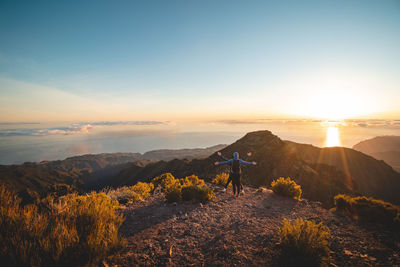 Candid portrait of two brothers who climbed the highest mountain pico ruivo in madeira, portugal. 