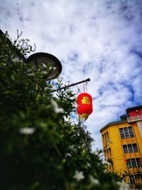 Low angle view of red lanterns hanging against sky