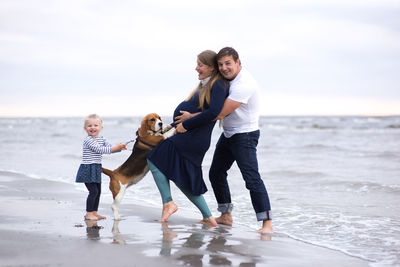 Full length of happy family at beach