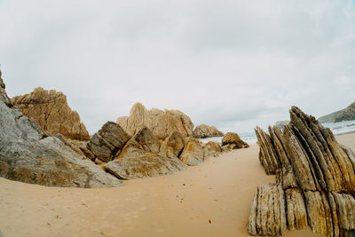 Rock formation on land against sky