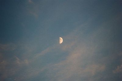 Low angle view of moon in sky at night