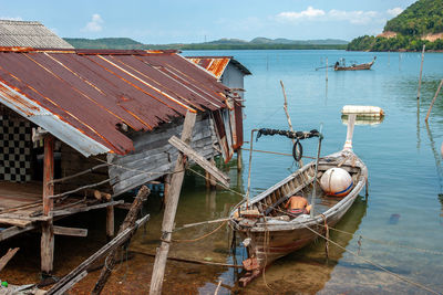 Boat moored in sea against sky