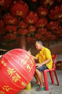 Rear view of woman sitting on ground