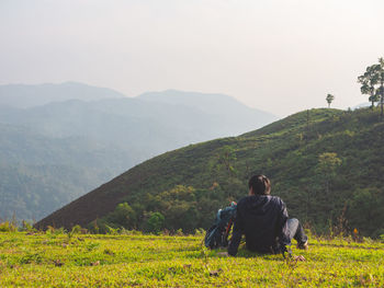 Trekking solo backpack on mountain trail in tropical forest at tak province, thailand.