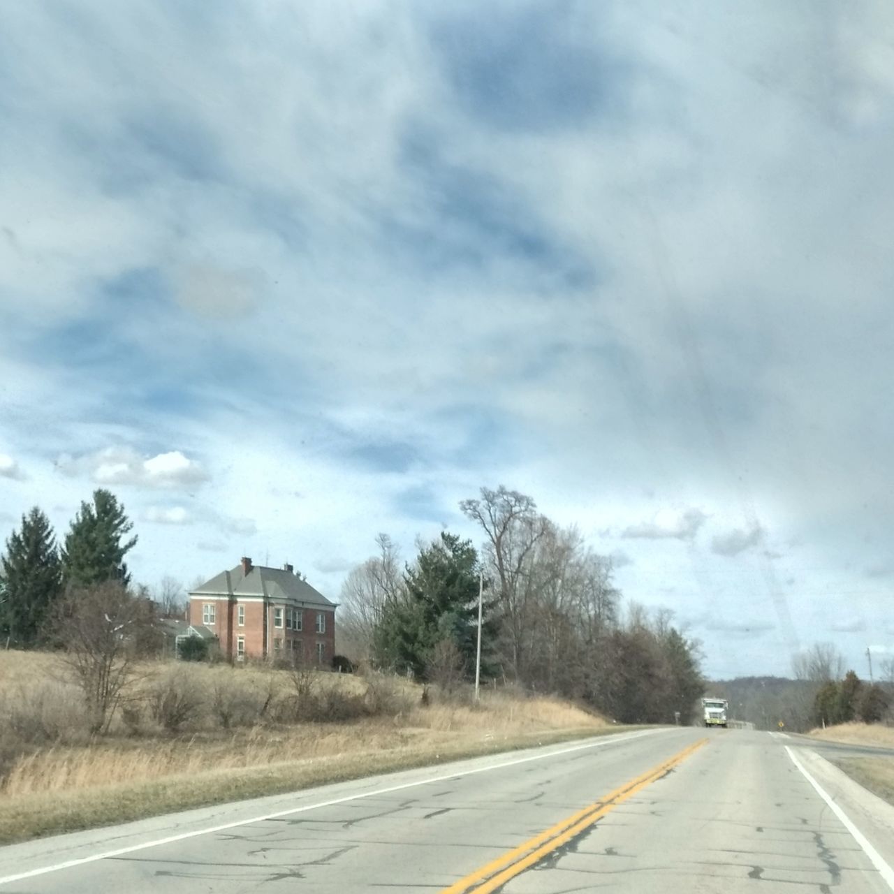 ROAD BY BUILDING AGAINST SKY