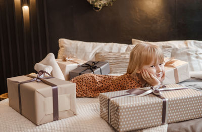 Portrait of smiling child sitting on sofa at home