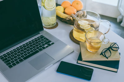 Morning time at home healthy breakfast laptop and phone on table. natural meal and drink at work