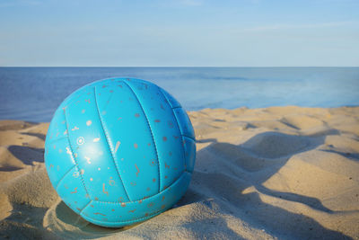 Volleyball in the sand with sandals at the beach