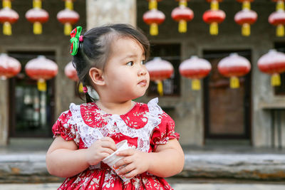 Close-up of cute girl looking away