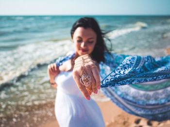 Close-up of young woman standing on beach