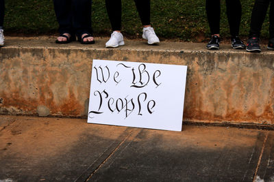 Low section of woman standing on text
