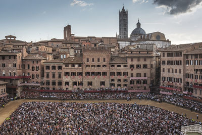 Group of people in front of building. piazza del campo, siena. 