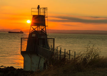 Scenic view of sea against orange sky