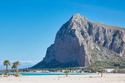 Scenic view of beach against clear blue sky