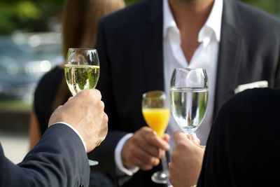 People toasting with glasses of champagne in party