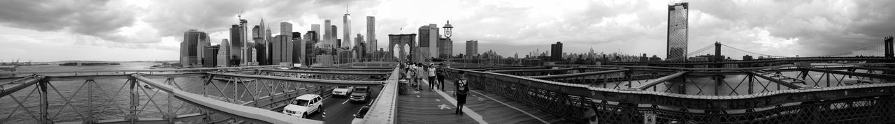 Panoramic view of bridge and buildings against sky