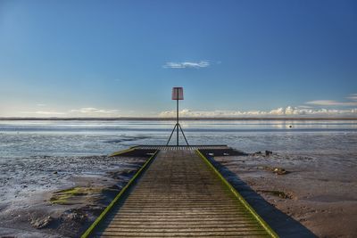 Pier over sea against sky