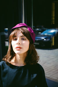 Portrait of beautiful young woman wearing purple hair bow