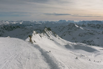 Scenic view of snow covered mountains against sky