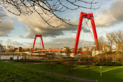 Golden gate bridge in city against cloudy sky