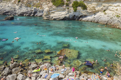 High angle view of people swimming in sea