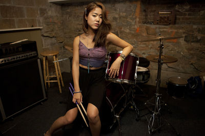 Young woman standing by her drum kit