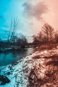 Scenic view of frozen lake against sky during winter