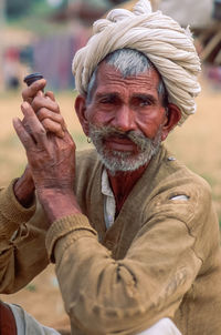 Portrait of man holding camera