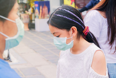 Portrait of woman looking at city street