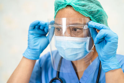 Midsection of doctor wearing protective mask