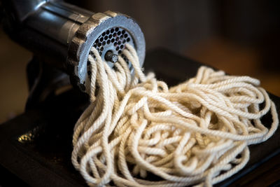 Close-up of machinery with ropes on table