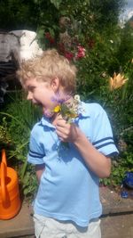 Happy boy with flowers in park