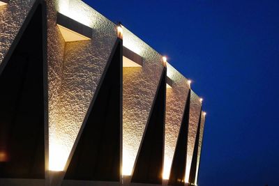 Low angle view of sun shining through built structure