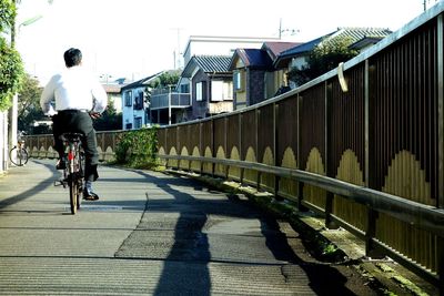 Rear view of man cycling on bicycle