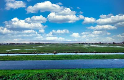 Scenic view of farm against sky