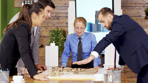 Side view of business colleagues working at table