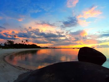 Scenic view of lake against sky during sunset