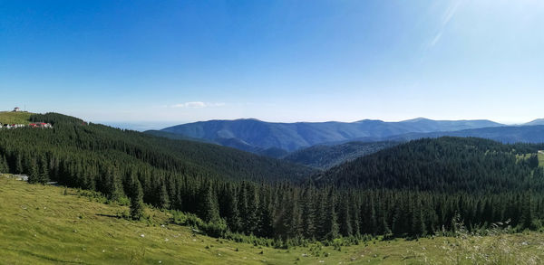 Scenic view of mountains against blue sky