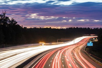 High angle view of light trails on road at night