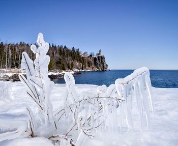 Scenic view of sea against clear sky during winter