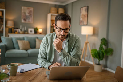 Young man using laptop at home